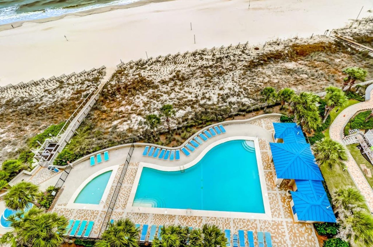 Overhead view of the outdoor pool and pool deck at Bluewater Condominiums