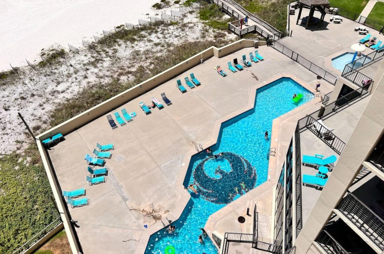Aerial view of the swimming pool and pool deck next to the beach at Phoenix II
