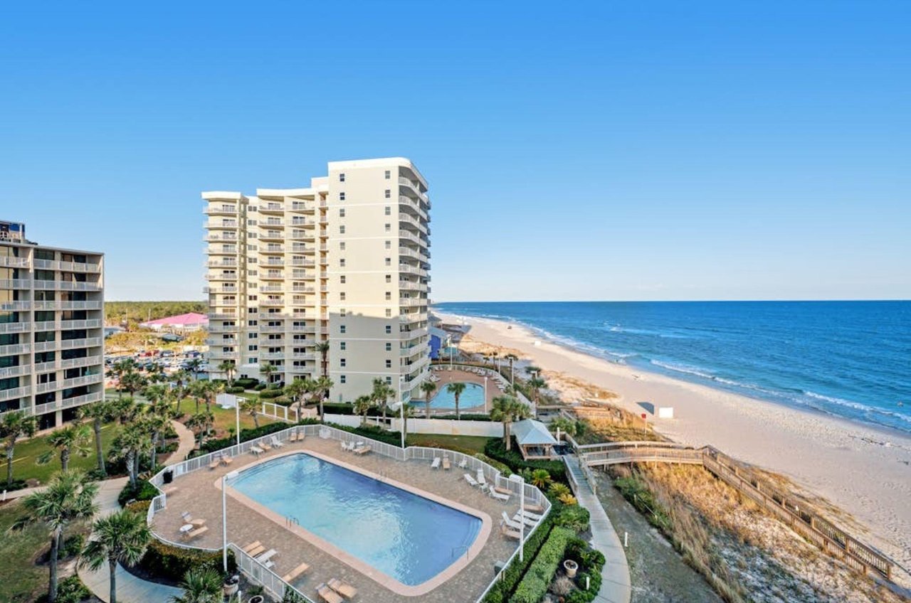A view looking down the view beach from a private balcony at Seaside Beach and Racquet Club