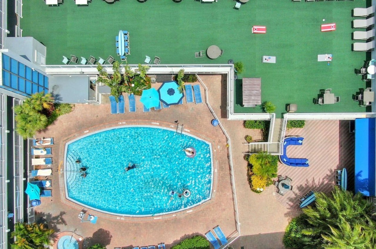 Overhead view of a beachside outdoor pool and rooftop sun deck