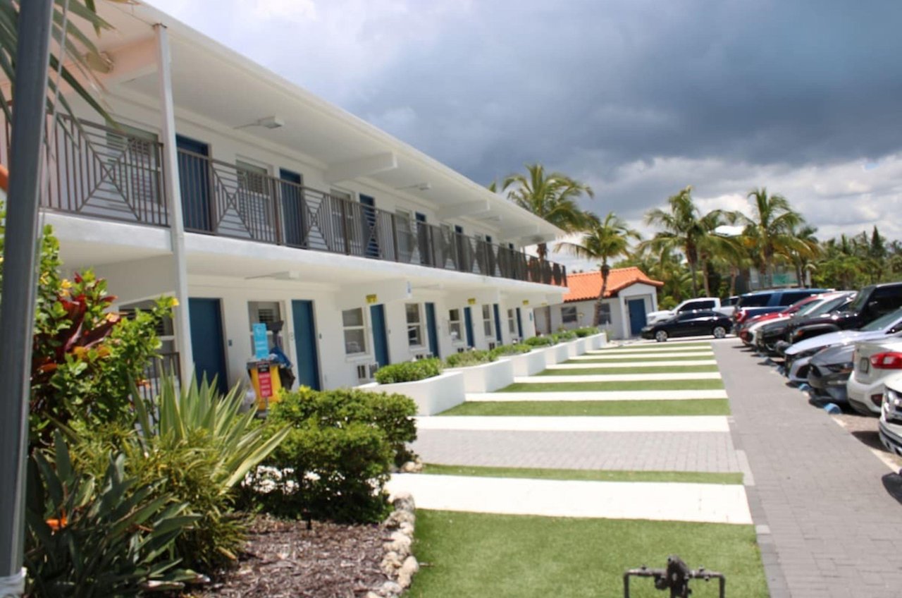 The exterior of Siesta Key Beach Resort and Suites with complimentary parking spots in front