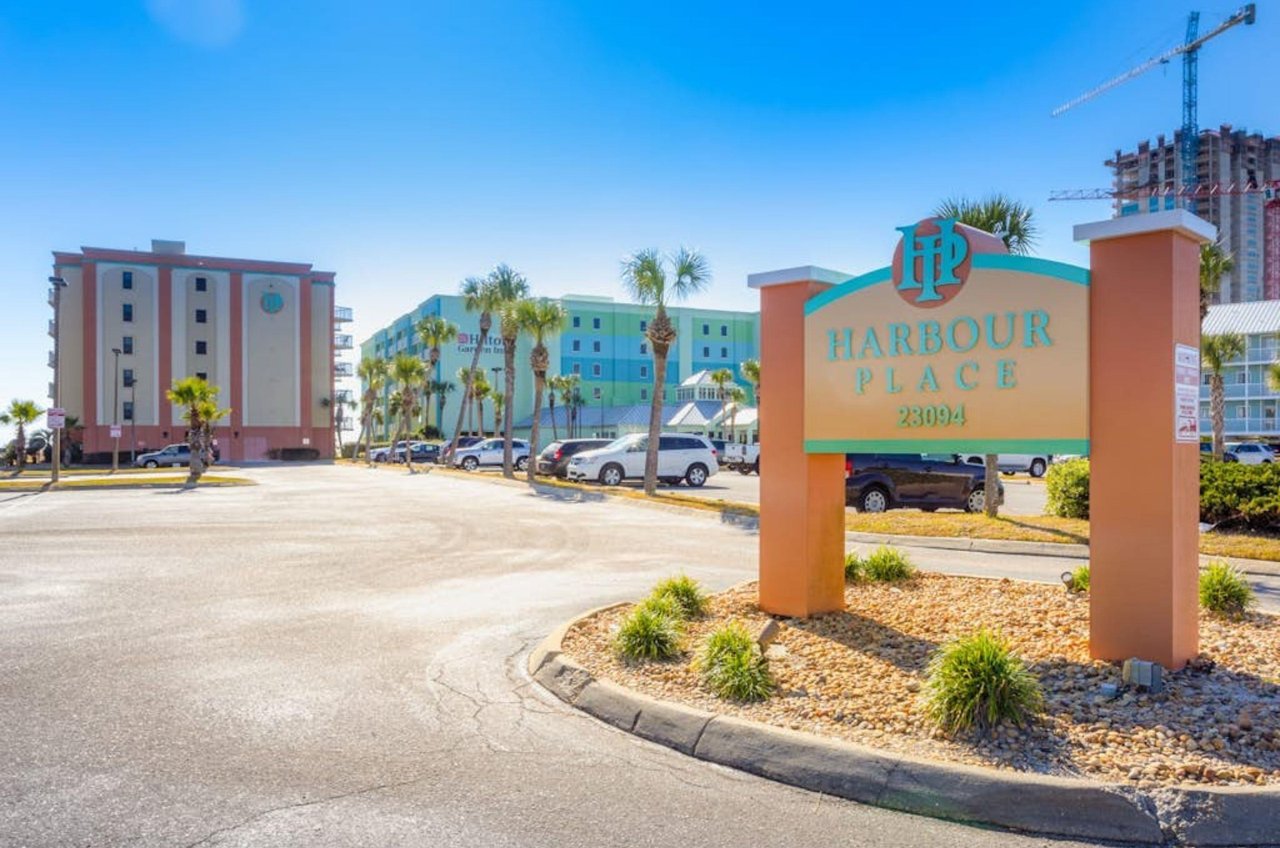 View from the street of Harbour Place and the propertys entry sign in Orange Beach Alabama