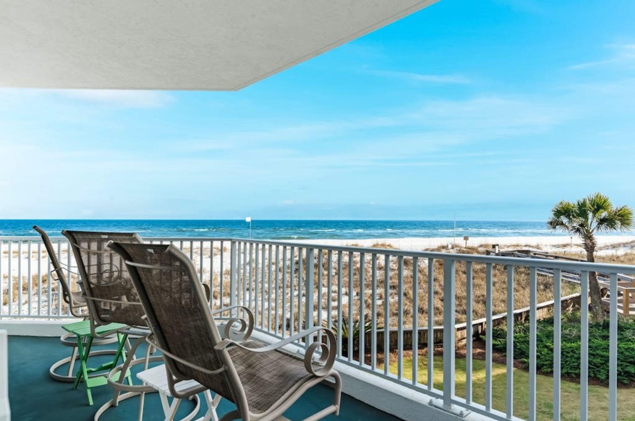 Lounge chairs on a balcony overlooking the beach at Palm Beach Condos in Orange Beach Alabama