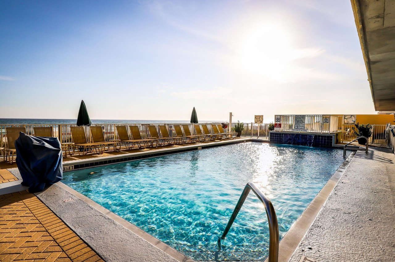 The beachside outdoor swimming pool at Emerald Isle Condominiums
