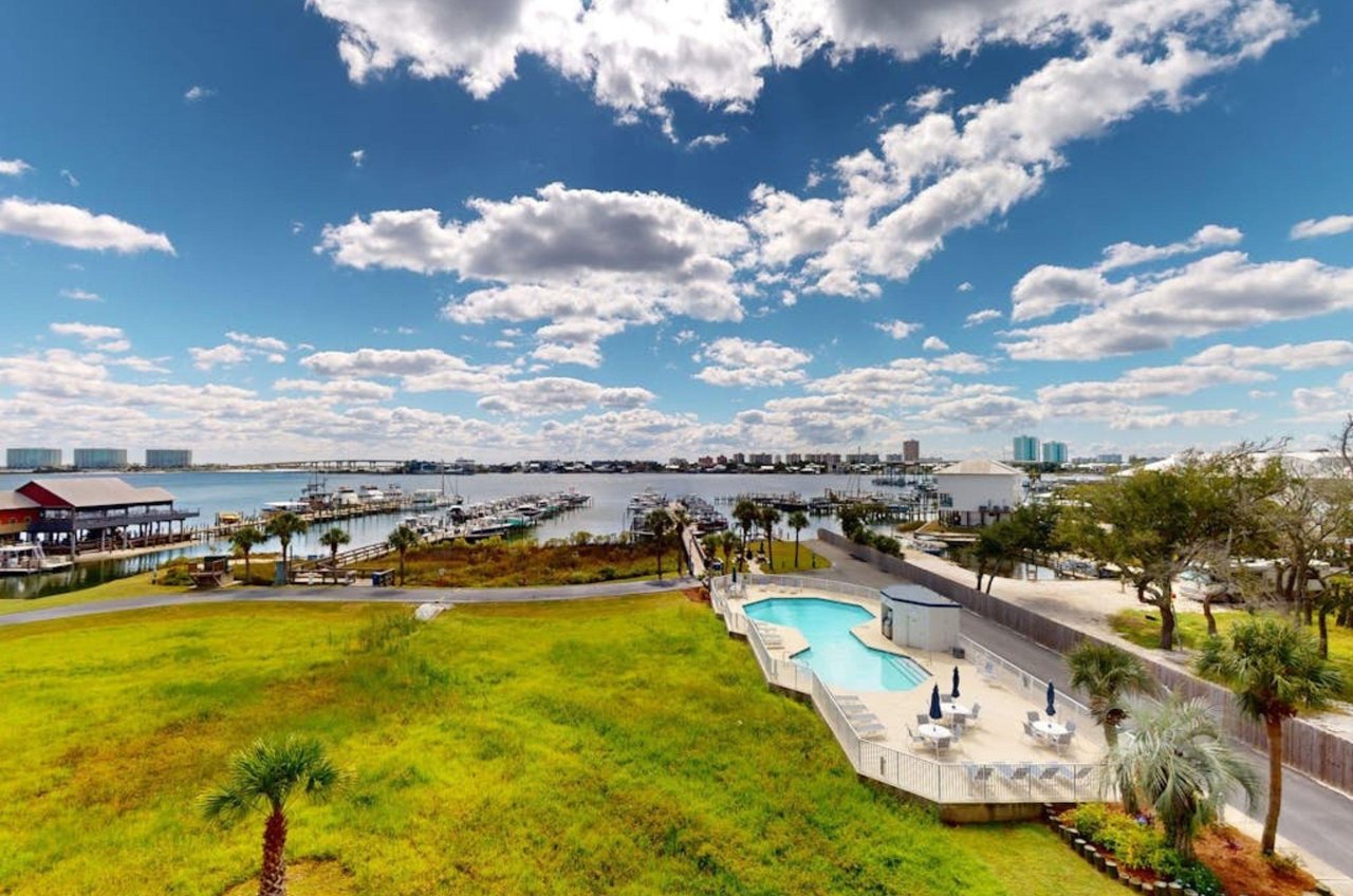 View from a balcony of the outdoor pool and the wooden piers on Terry Cove