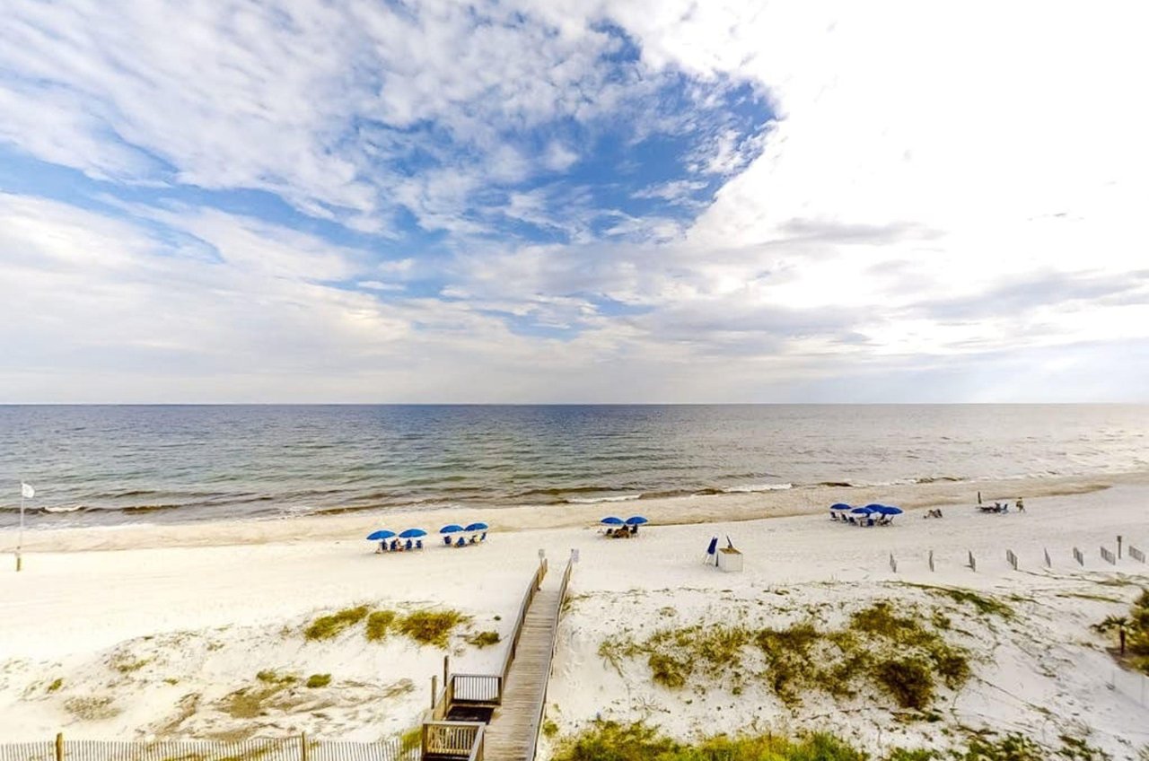 View from a private balcony of the wooden walkway leading to the beach at Dolphin Key