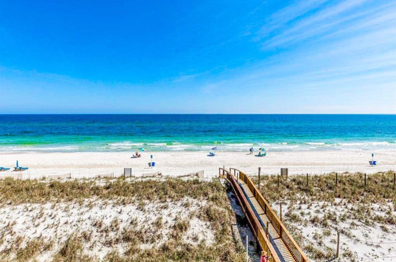 View from a private balcony of the beach and a wooden walkway leading to the Gulf