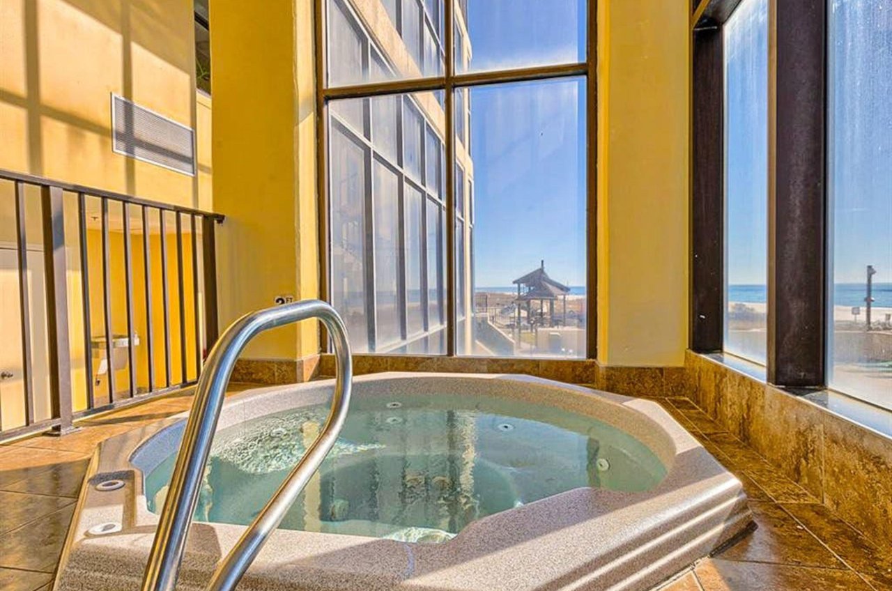 The indoor hot tub next to windows at Phoenix I in Orange Beach Alabama