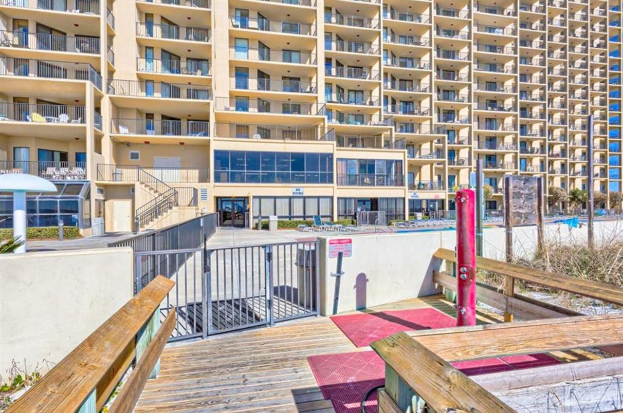 View from the boardwalk of the beachside exterior of Phoenix V in Orange Beach Alabama