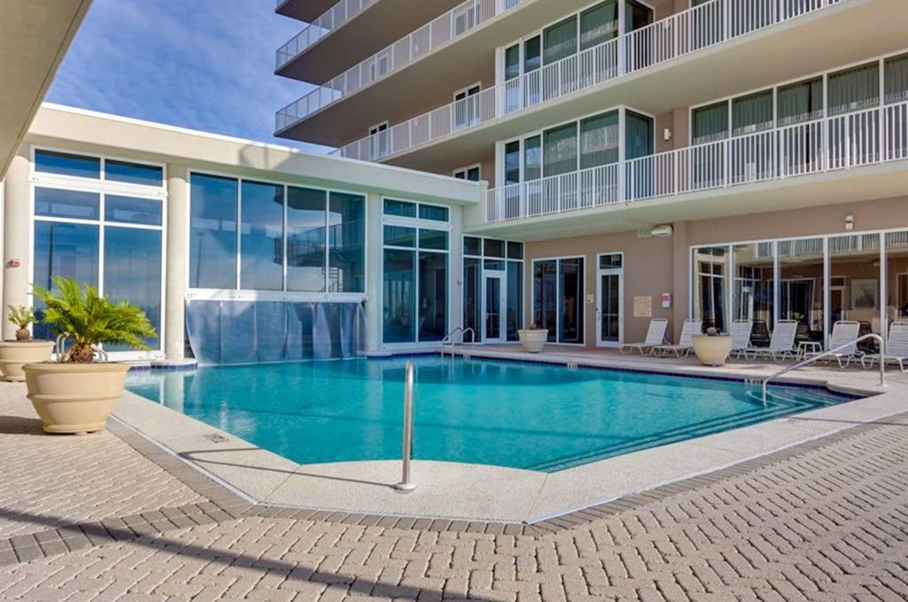 The outdoor swimming pool in front of the Mediterranean Condominiums