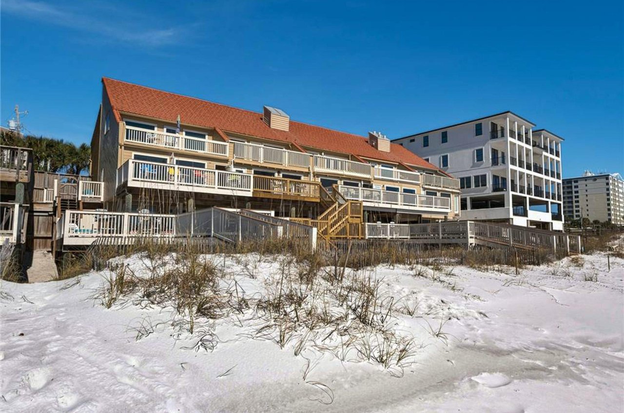 The complex sits nestled beside the beach.