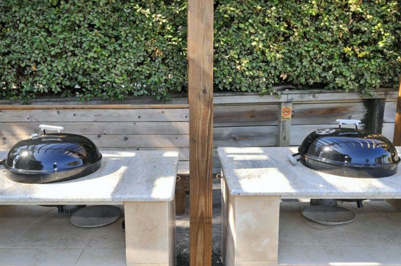 Charcoal grills stand ready for guests to use.