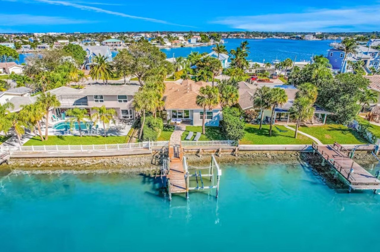 This vacation home is waterfront, spacious and has a beautiful swimming pool.