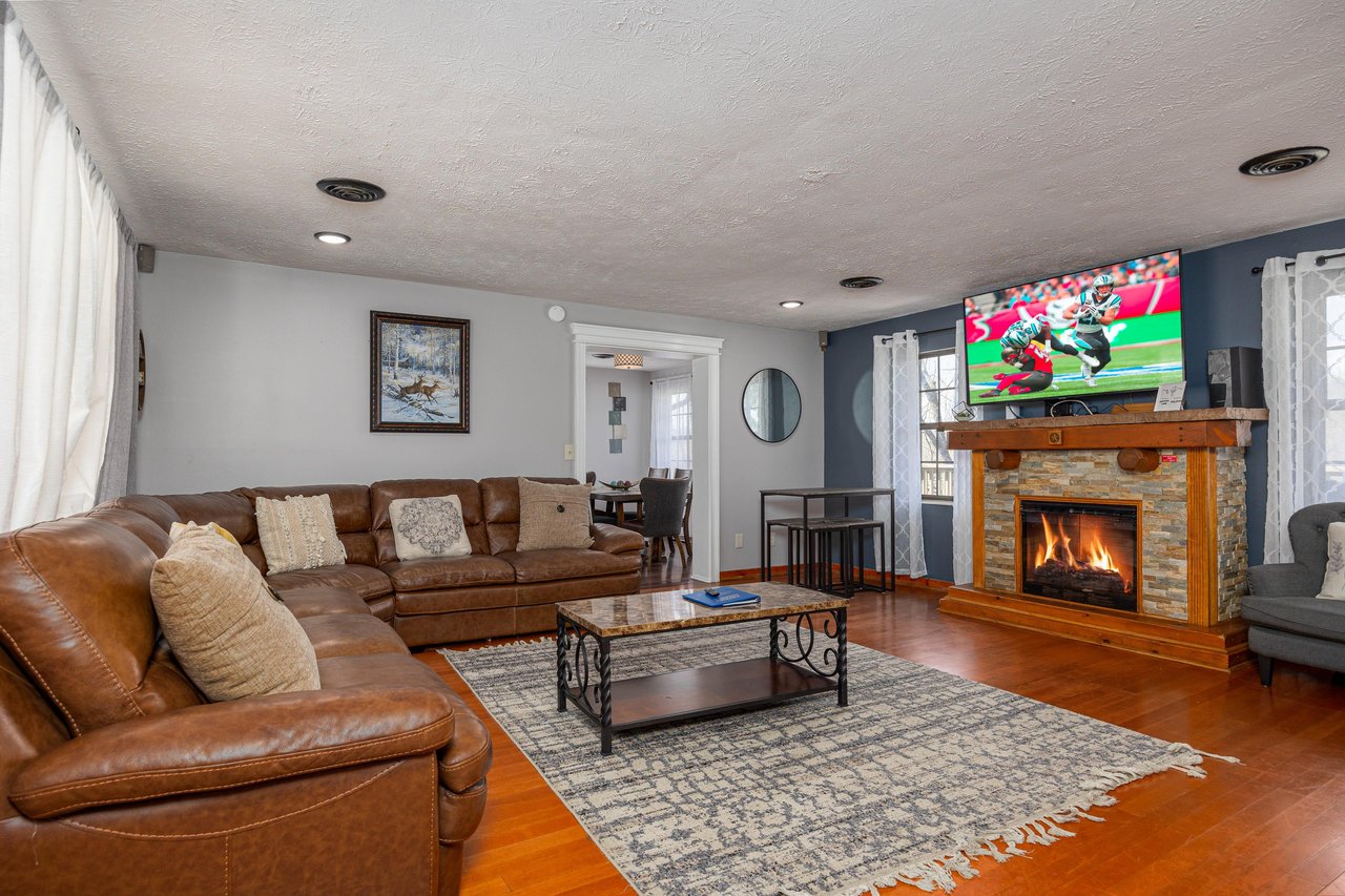 Livingroom with Sectional, flat screen, and fireplace at Hoop Dreams Lodge
