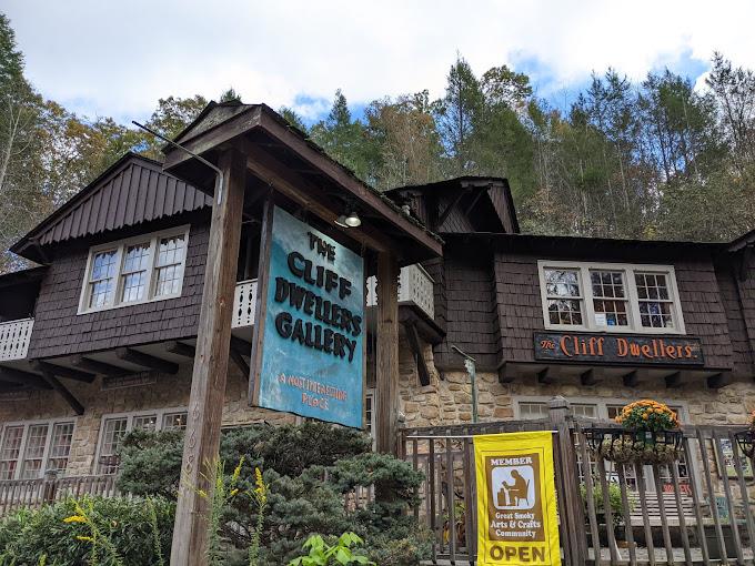 Brown English tutor style building with a yellow sign out front