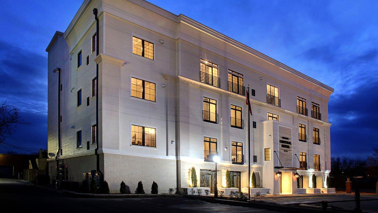 White building with multiple stories pictured at night