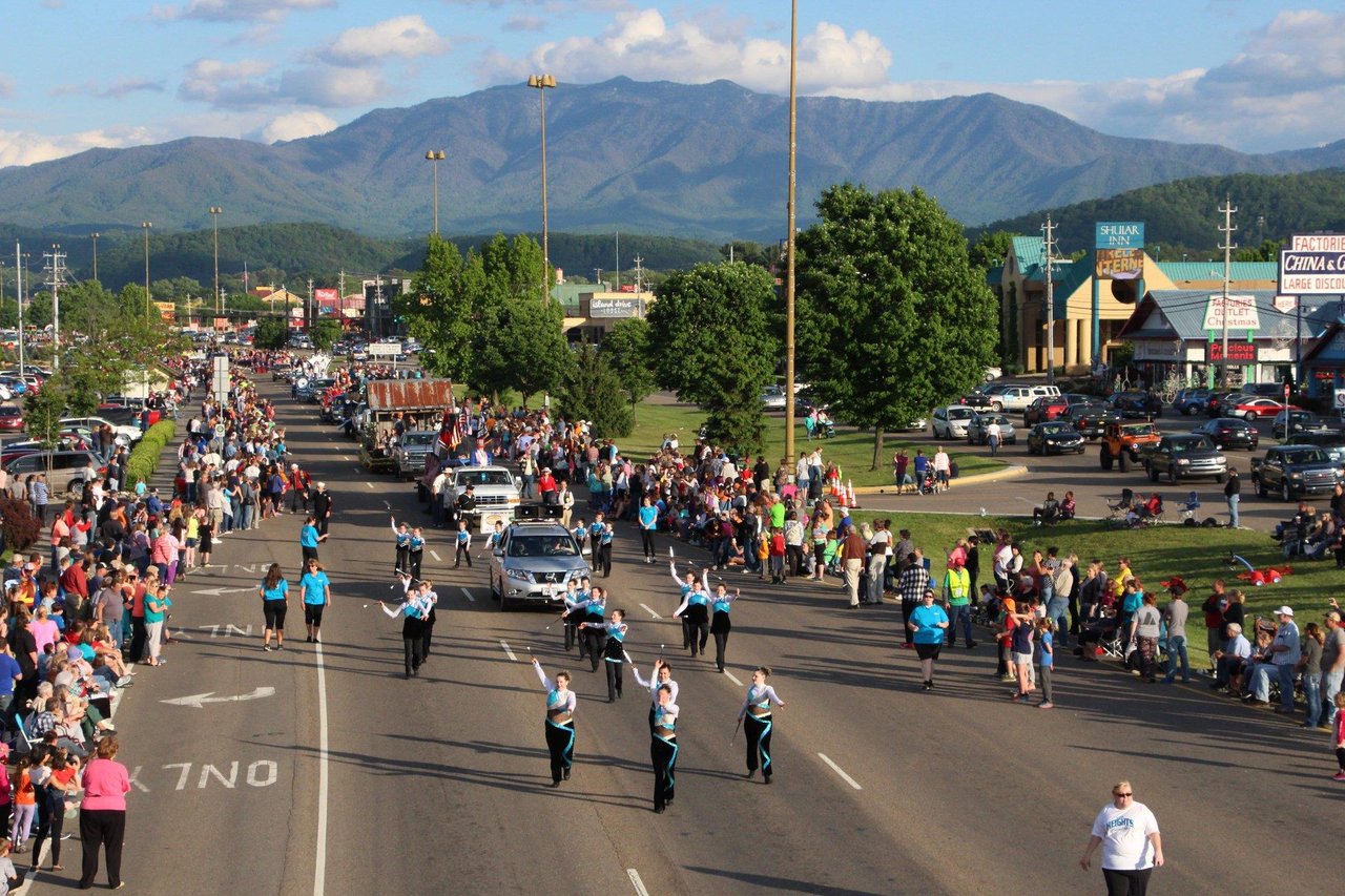 Cars and many people walking on a road