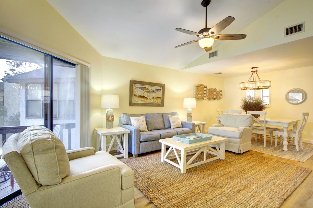 Bright, open living and dining space at 406 Harbour Oaks, perfect for relaxing after a beach day or walking back from dinner at Barbara Jeans.