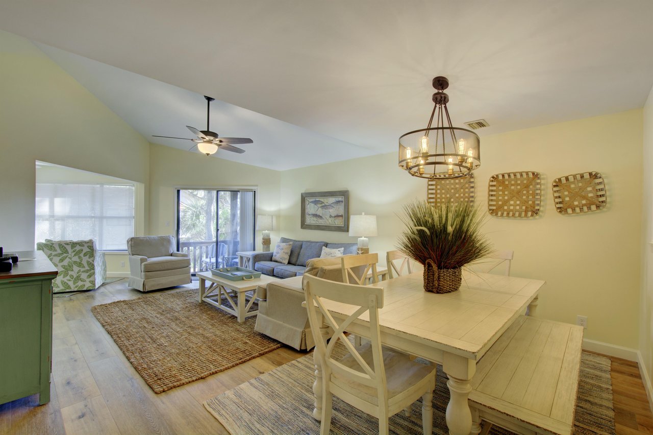From breakfast to movie night, this openconcept living and dining space at 406 Harbour Oaks offers natural light, high ceilings, and a breezy layout that leads to the screened porch.