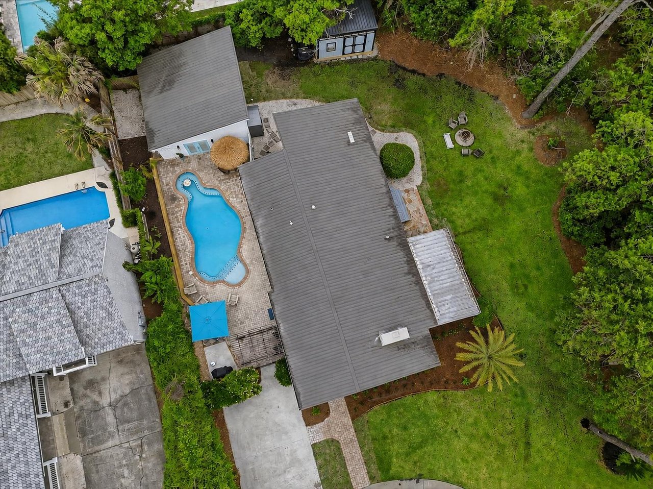 Overhead view of 530 Delegal showing the pool, courtyard, lawn, and outdoor gathering areas.
