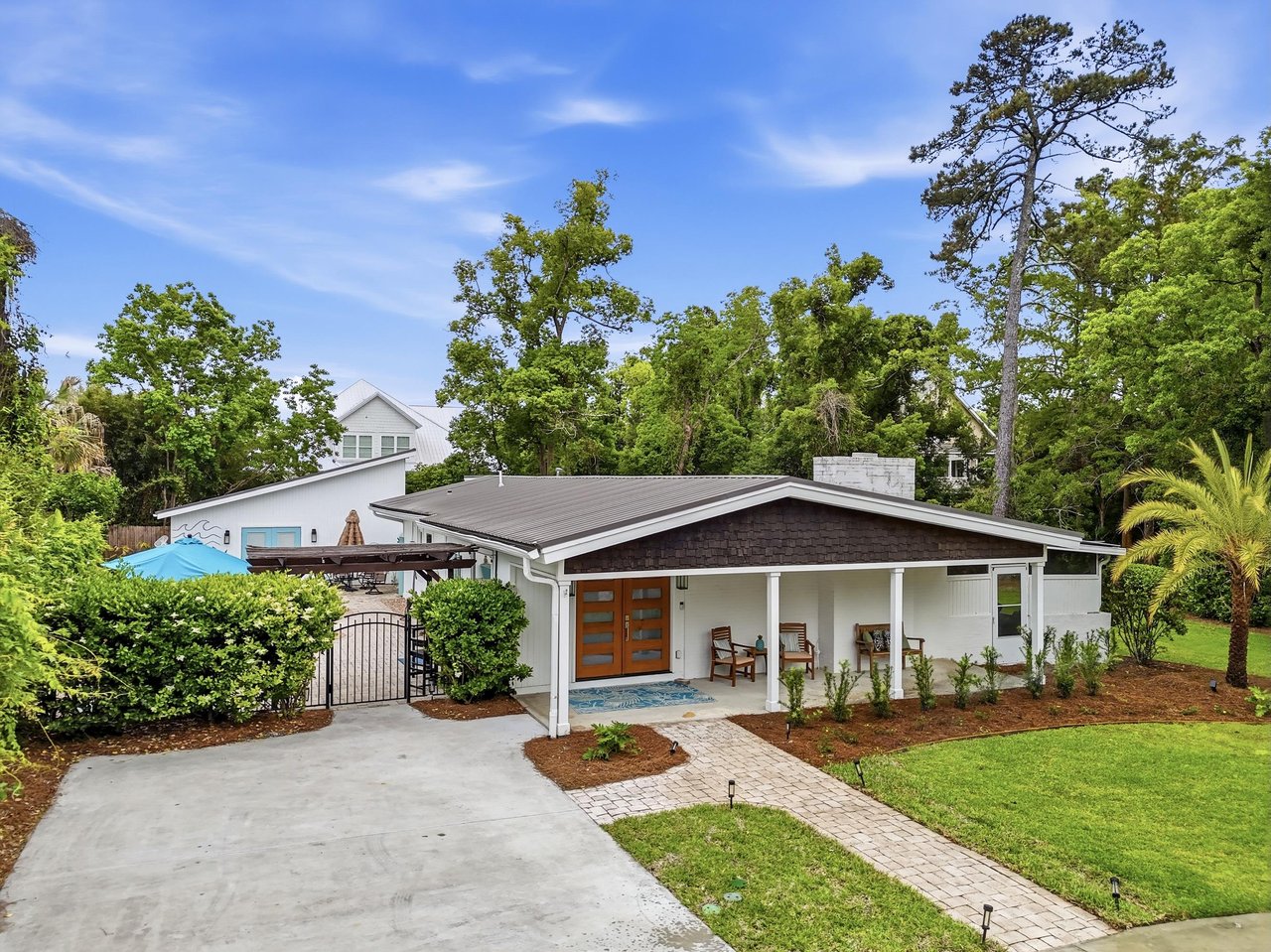Front exterior view of 530 Delegal showing the covered front porch, driveway, and landscaped yard.