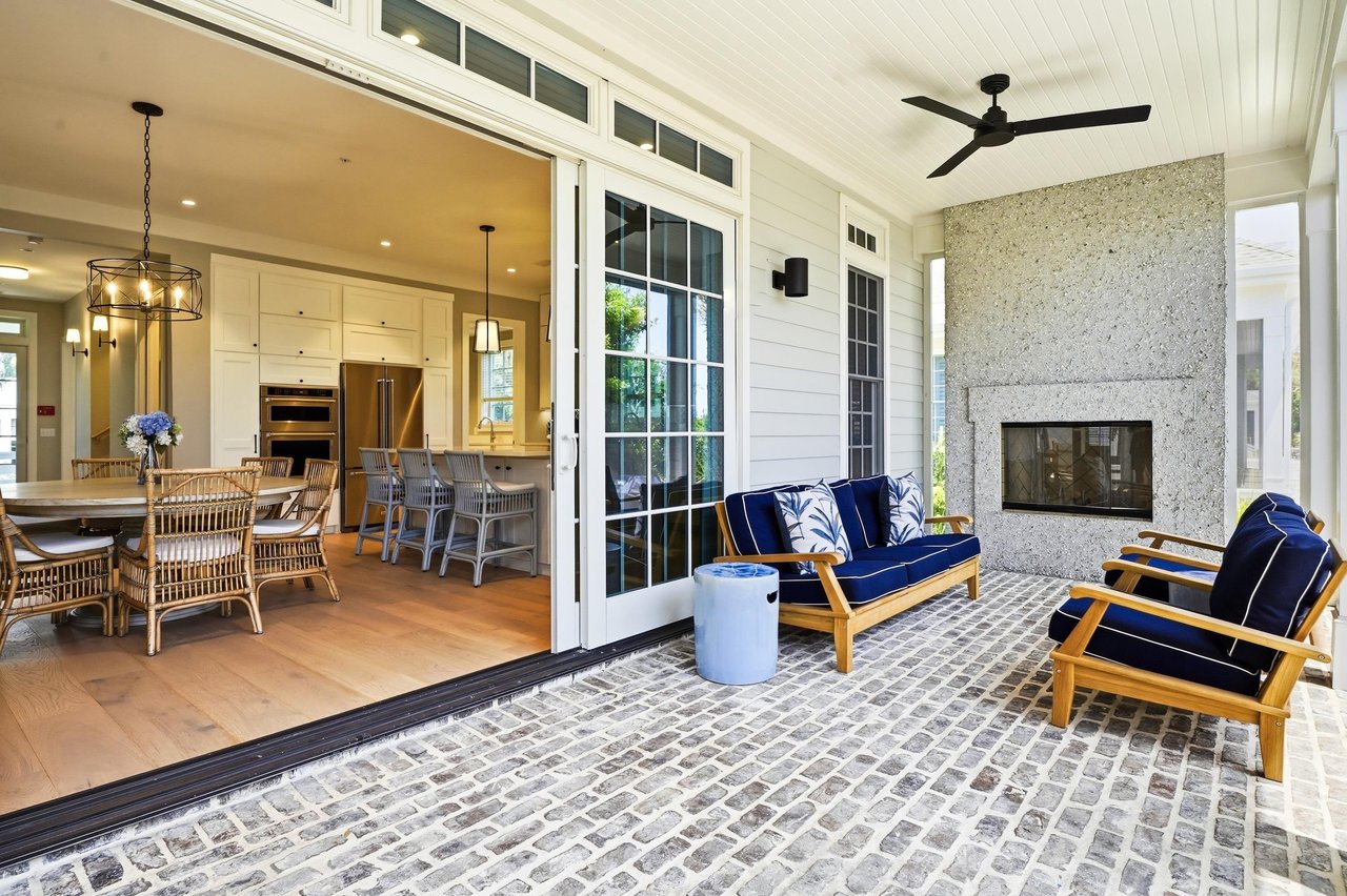 Wide doors connect the 35foot porch to the main gathering space, extending this oceanfront Jekyll Island rental outdoors.