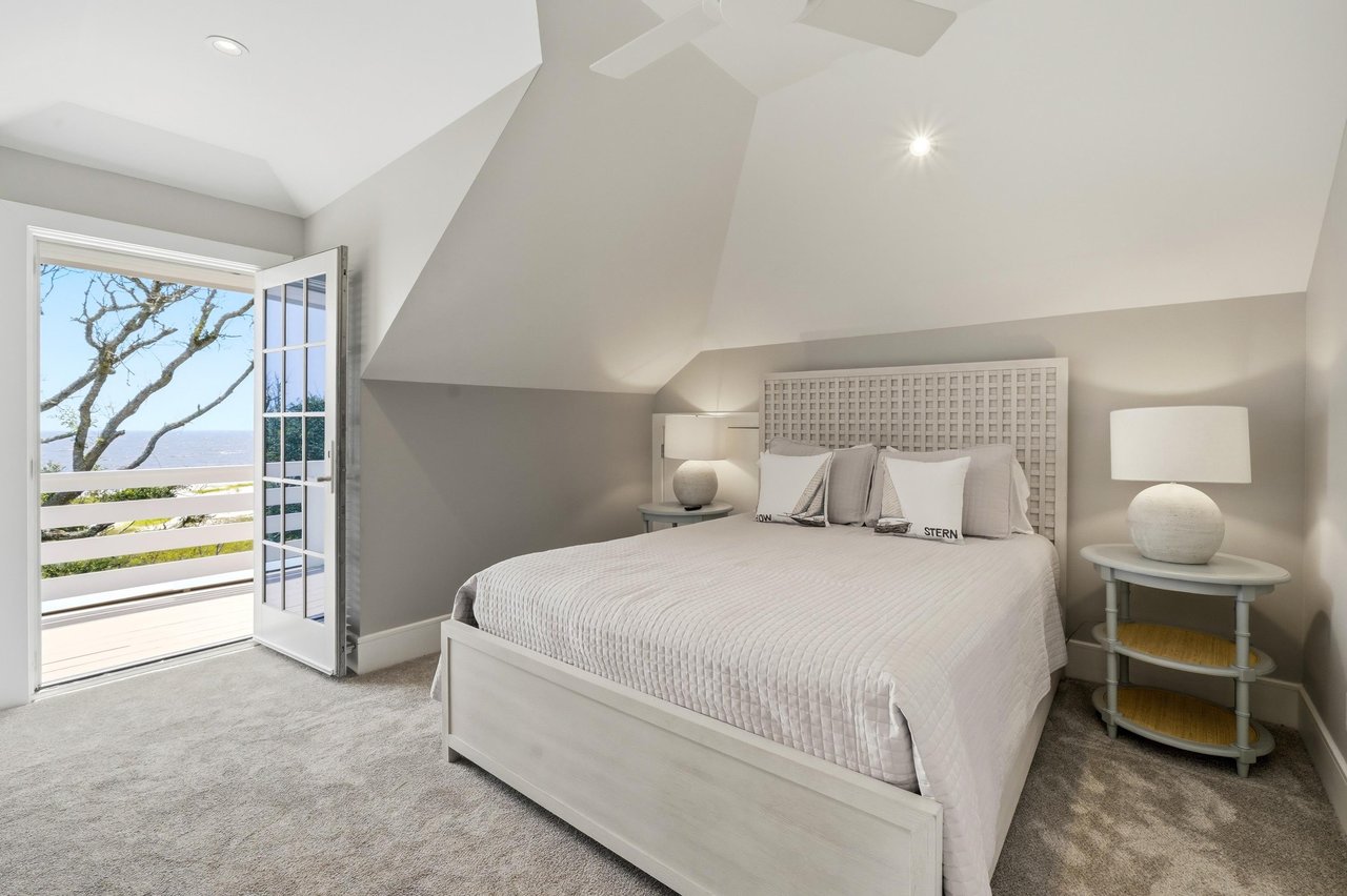 This upstairs queen bedroom opens to its own balcony overlooking the dunes and Atlantic.