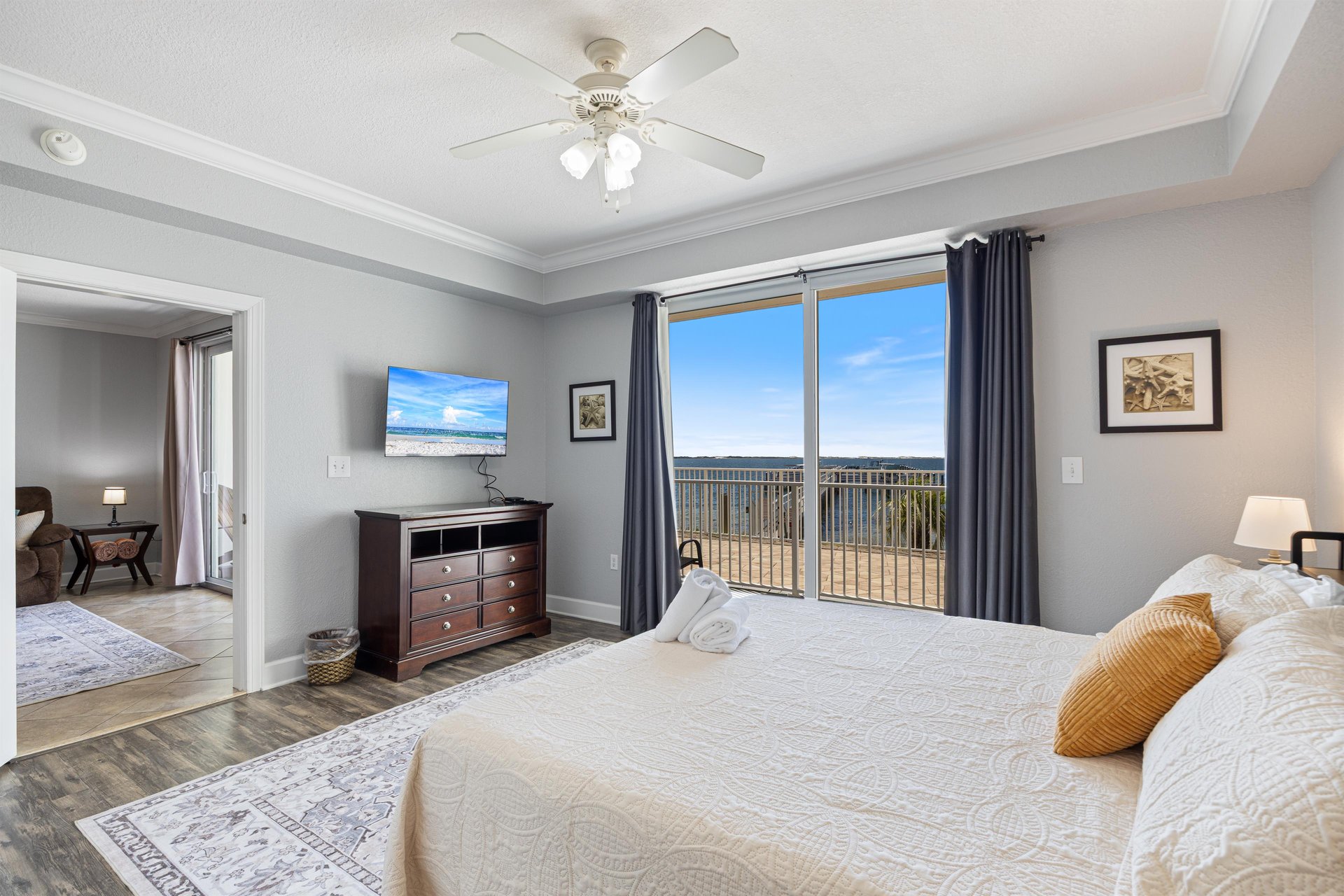 Spacious Primary Bedroom walks out to an incredible view of a picturesque marina and sparkling Intracoastal Waterway, with 8 miles of natural, undeveloped beach as a backdrop.