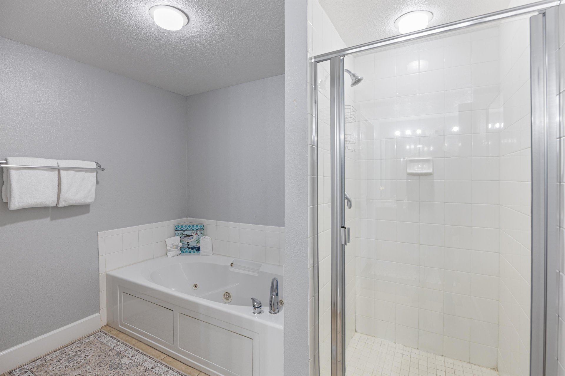 Separate shower, jetted tub and double vanities are featured in this Primary Bath.
