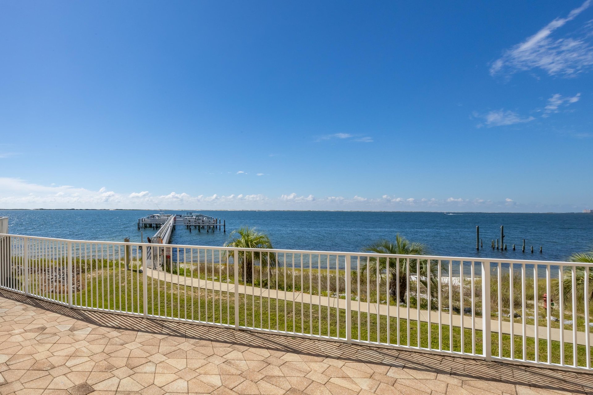 A huge pool deck with a view of the marina and a whole lot of natural beauty.