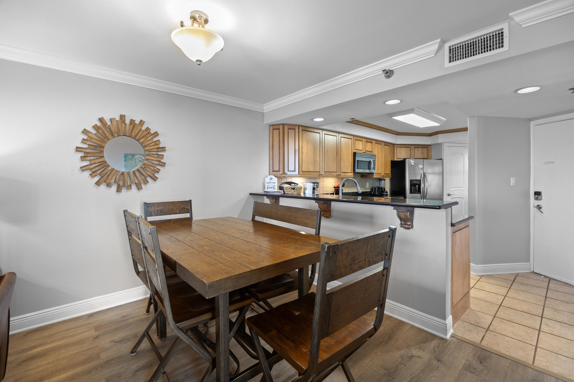 Breakfast bar separates kitchen from dining  living area.