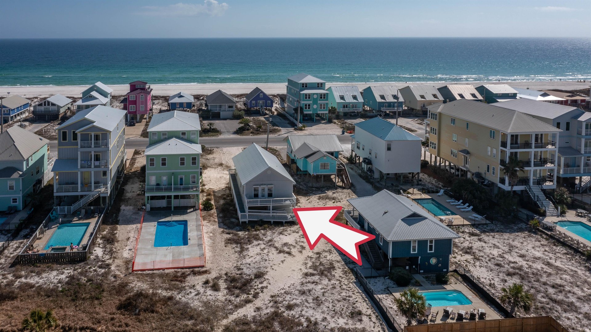 Private balcony with comfortable seating—perfect for morning coffee and coastal breezes just steps from the beach
