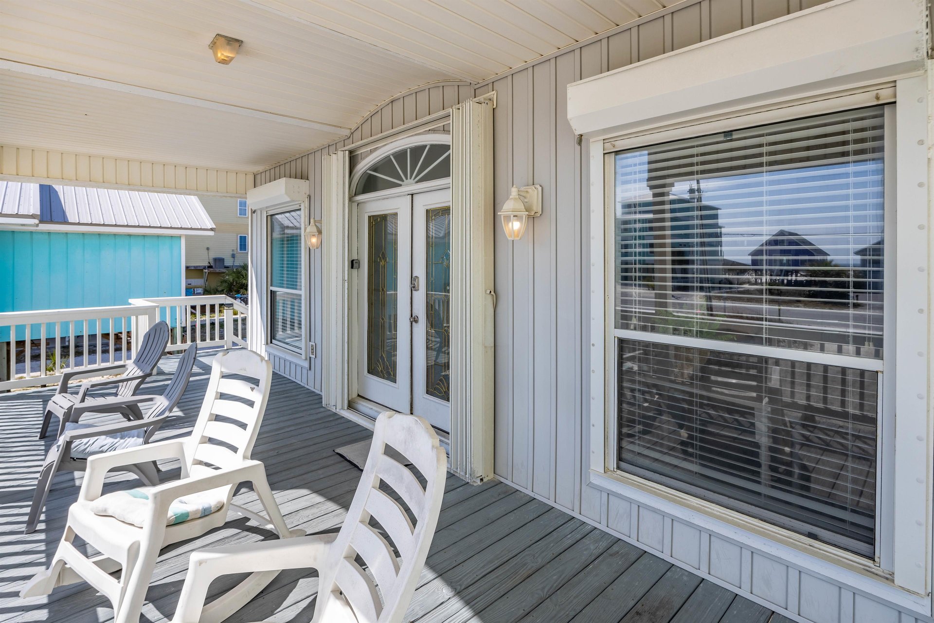 Welcoming front porch with seating—an inviting spot to unwind after a day at the beach