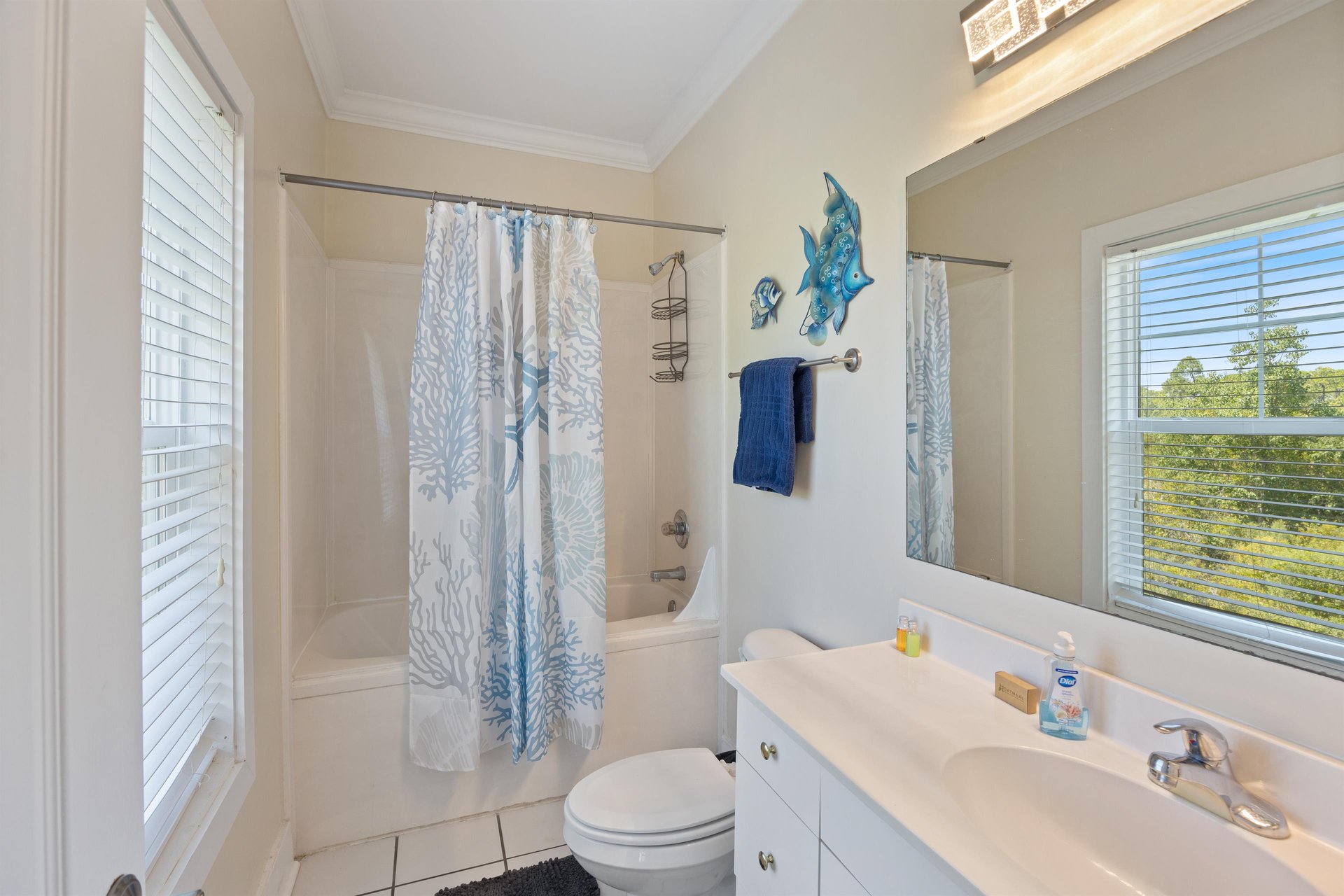 Full guest bathroom with tubshower combo—gives everyone their own space to get ready