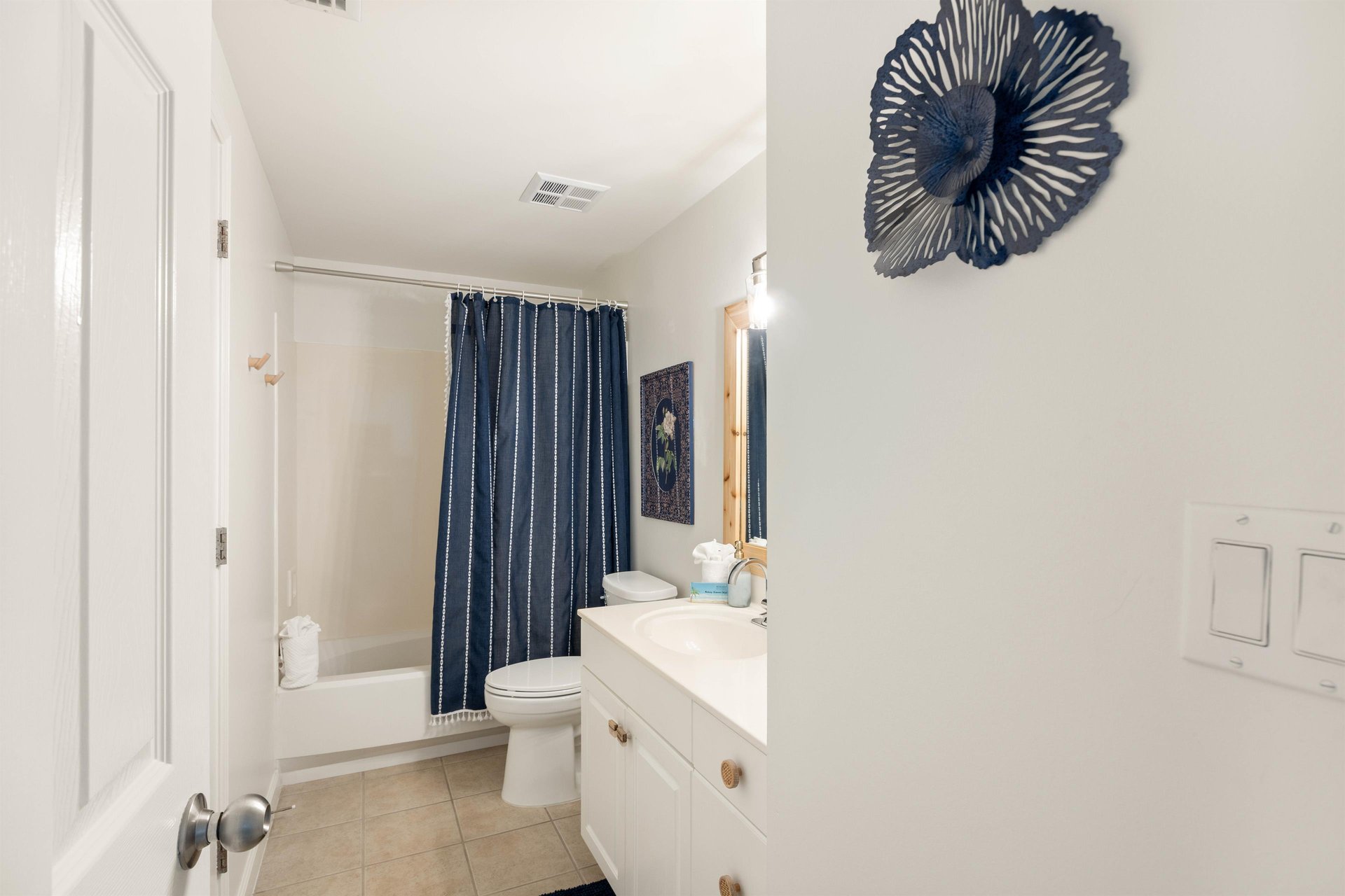Guest bath has a convenient tubshower combo.
