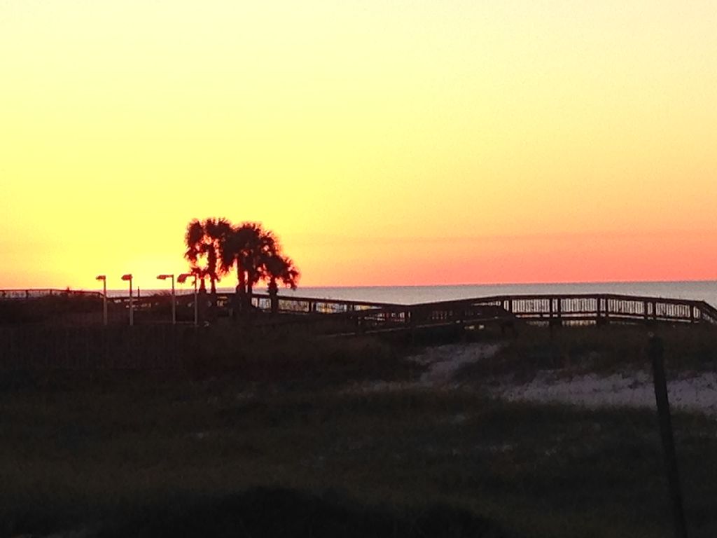 Molokai Perdido Key view of sunset from the deck of a beachside condo