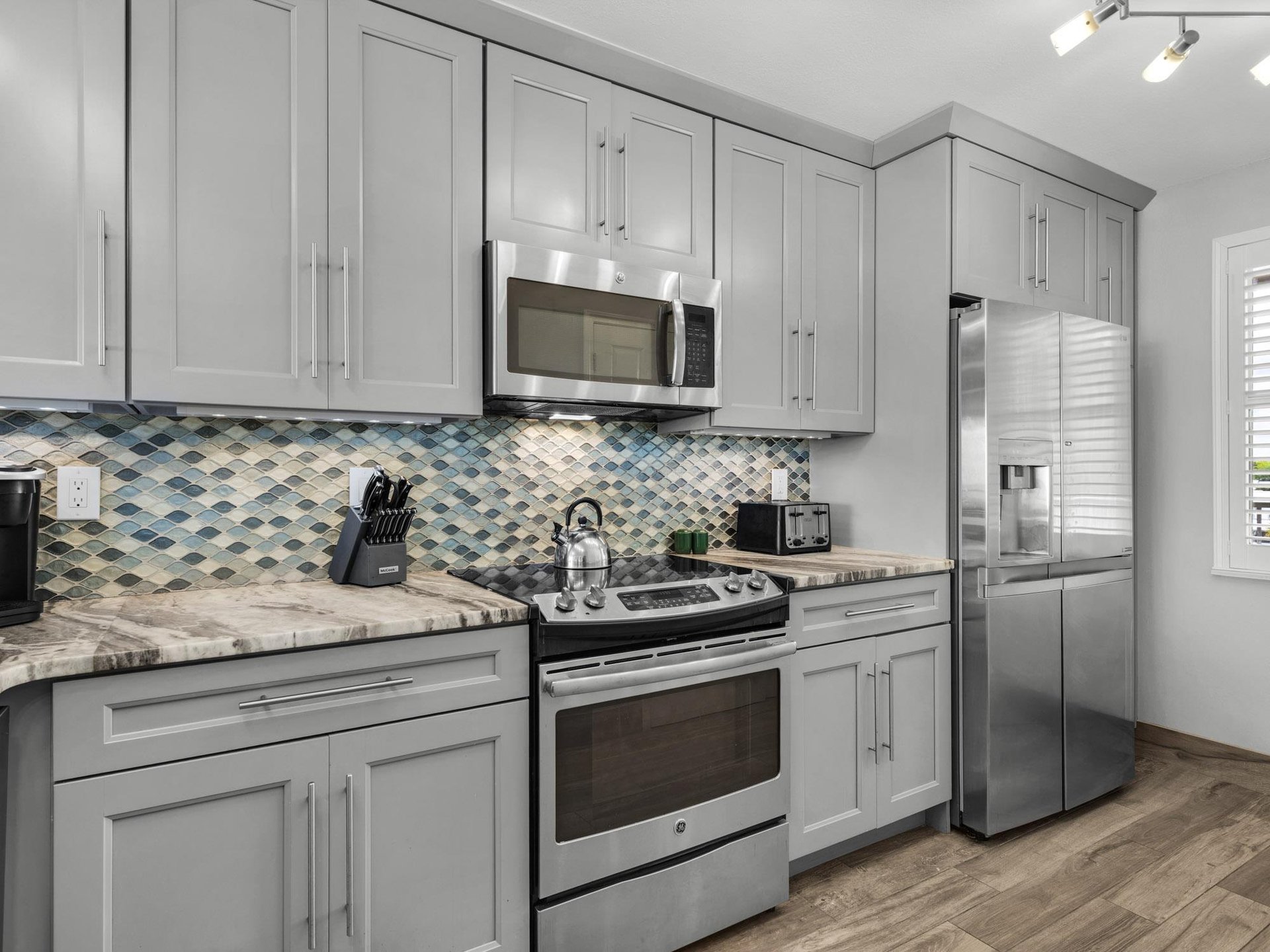 Stainless Steel Appliances, Custom Backsplash and Cabinets