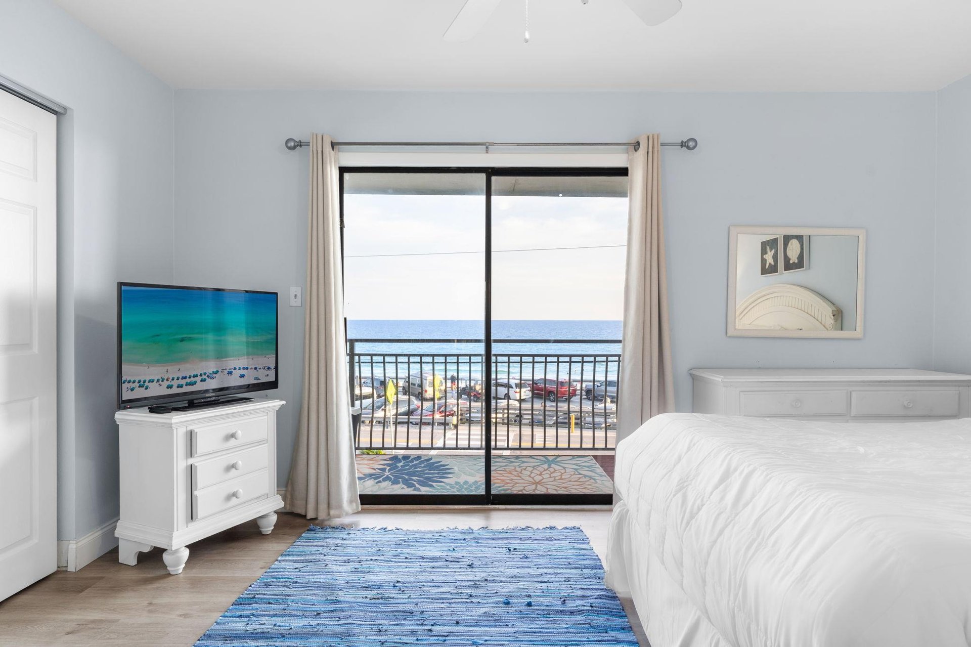 TV and Balcony and Gulf Views from Primary Bedroom