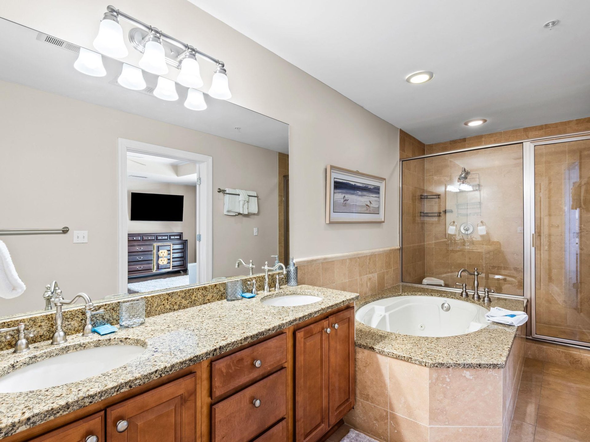 Unwind in your luxurious primary bathroom featuring granite countertops, deep soaking tub, and elegant finishes for ultimate relaxation.