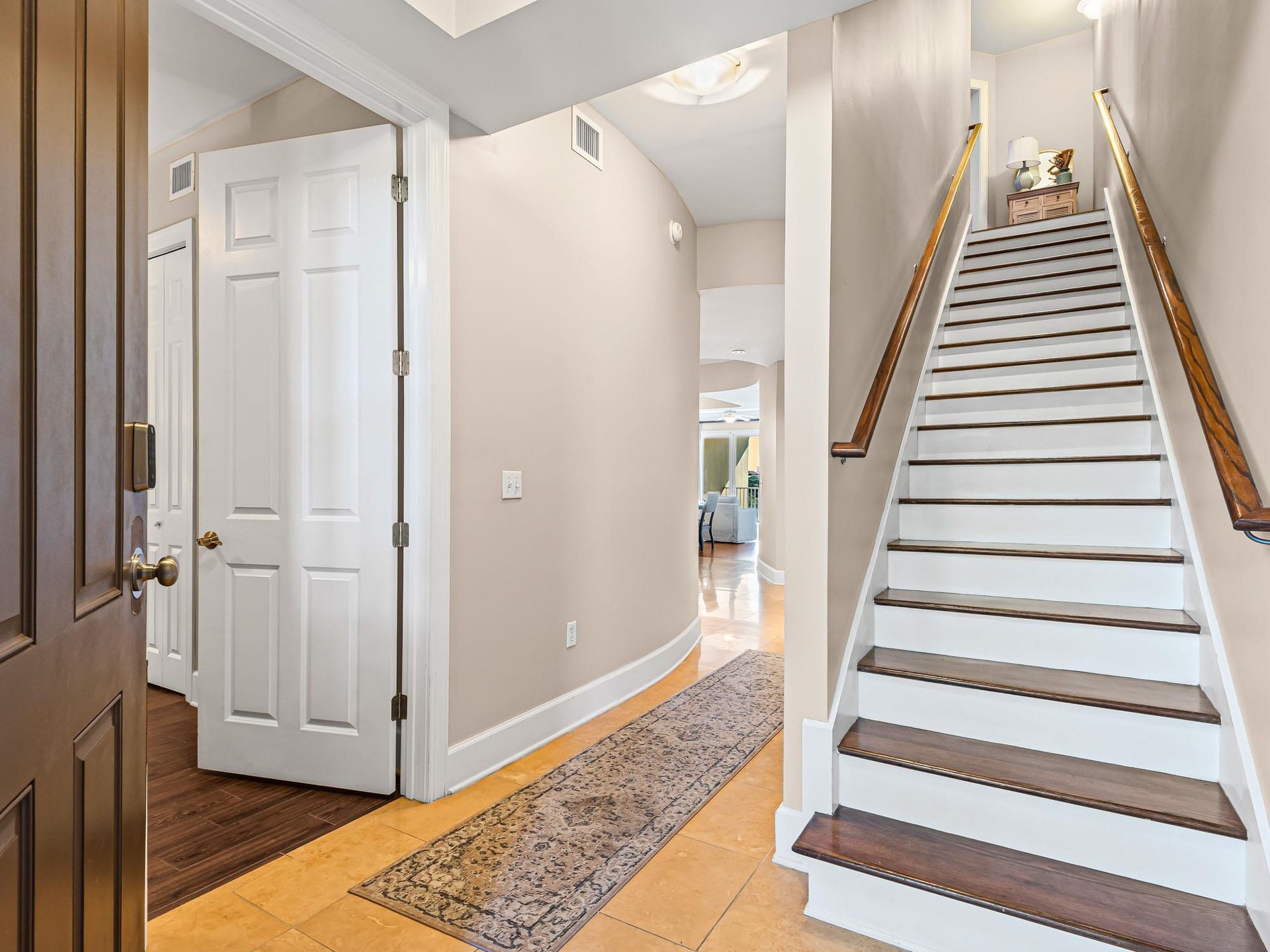 Step into your welcoming home away from home, where polished floors and warm neutral tones create an inviting atmosphere from the moment you arrive.