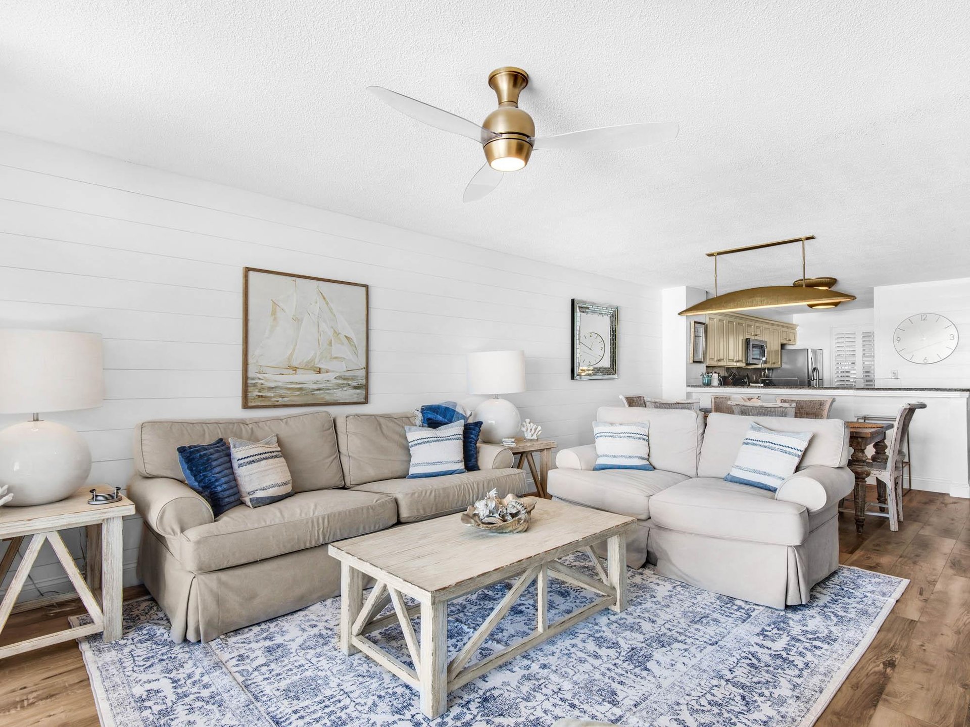 Sink into the plush sectional and let coastal charm embrace you in this bright living space with nautical art and oceanblue accents.