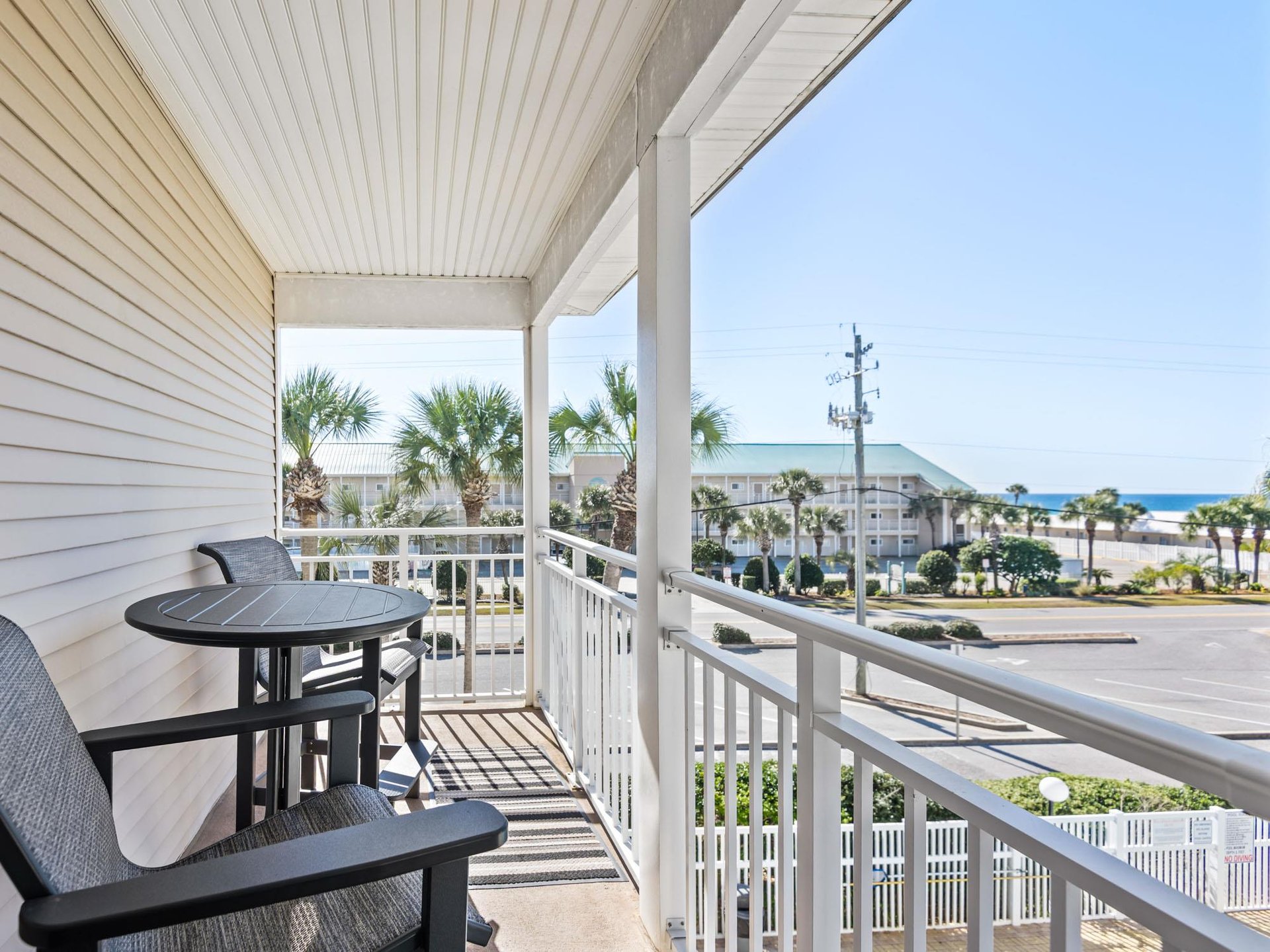Unwind on the private balcony with gulf glimpses, palm trees, and coastal breezes creating the perfect gulf oasis
