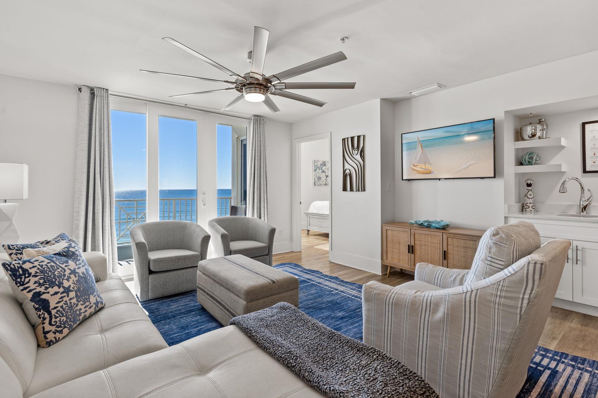 Relax in your coastal sanctuary with gulf views from every window, where the gentle ceiling fan and beachy decor create your perfect retreat.