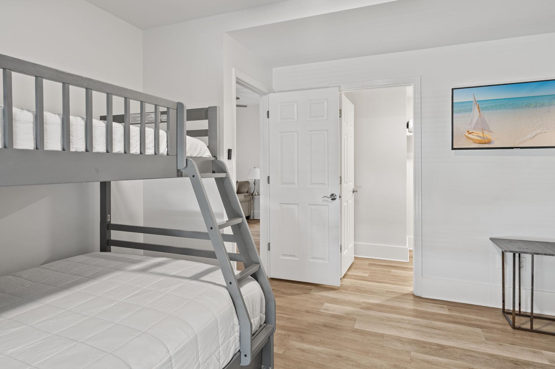 Your kids will love this coastalthemed twin over full bunk room with its sturdy gray beds and beach artwork—perfect for adventurous nights.