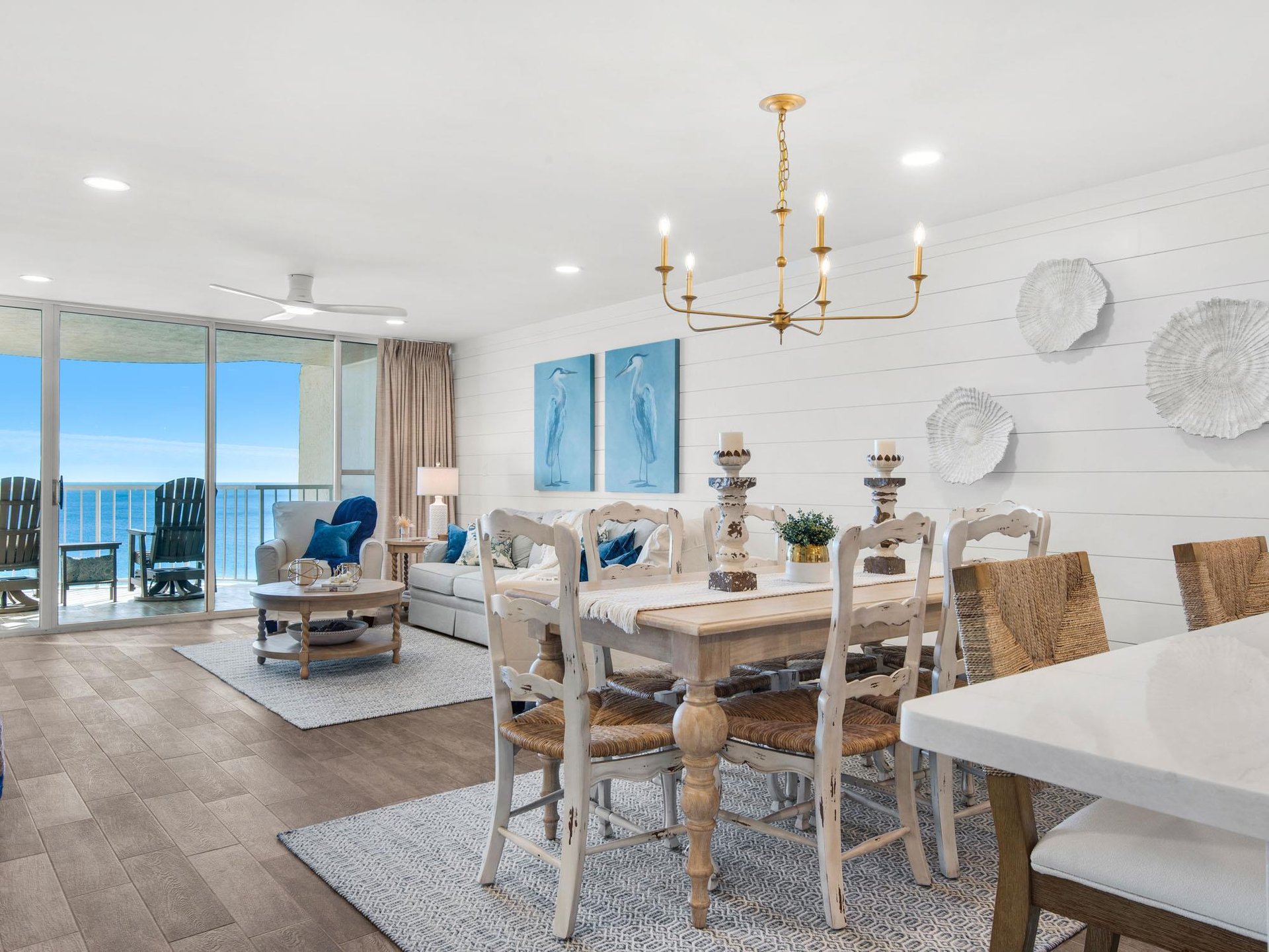 Relax in your bright coastal living space where ocean breezes flow through expansive windows and elegant furnishings create the perfect beachside retreat.