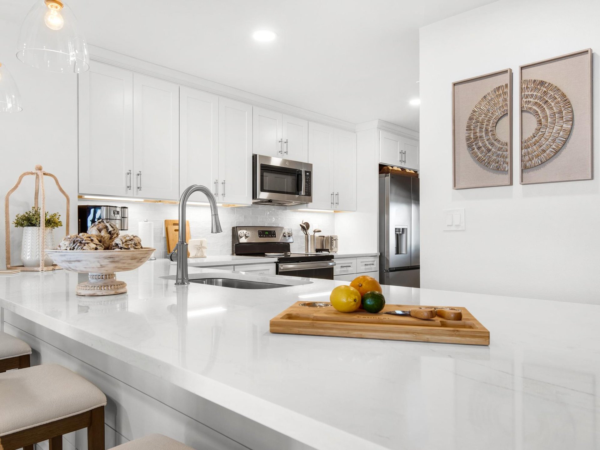 Your sleek modern kitchen awaits with pristine white countertops, stainless steel appliances, and thoughtful touches that make cooking a joy.