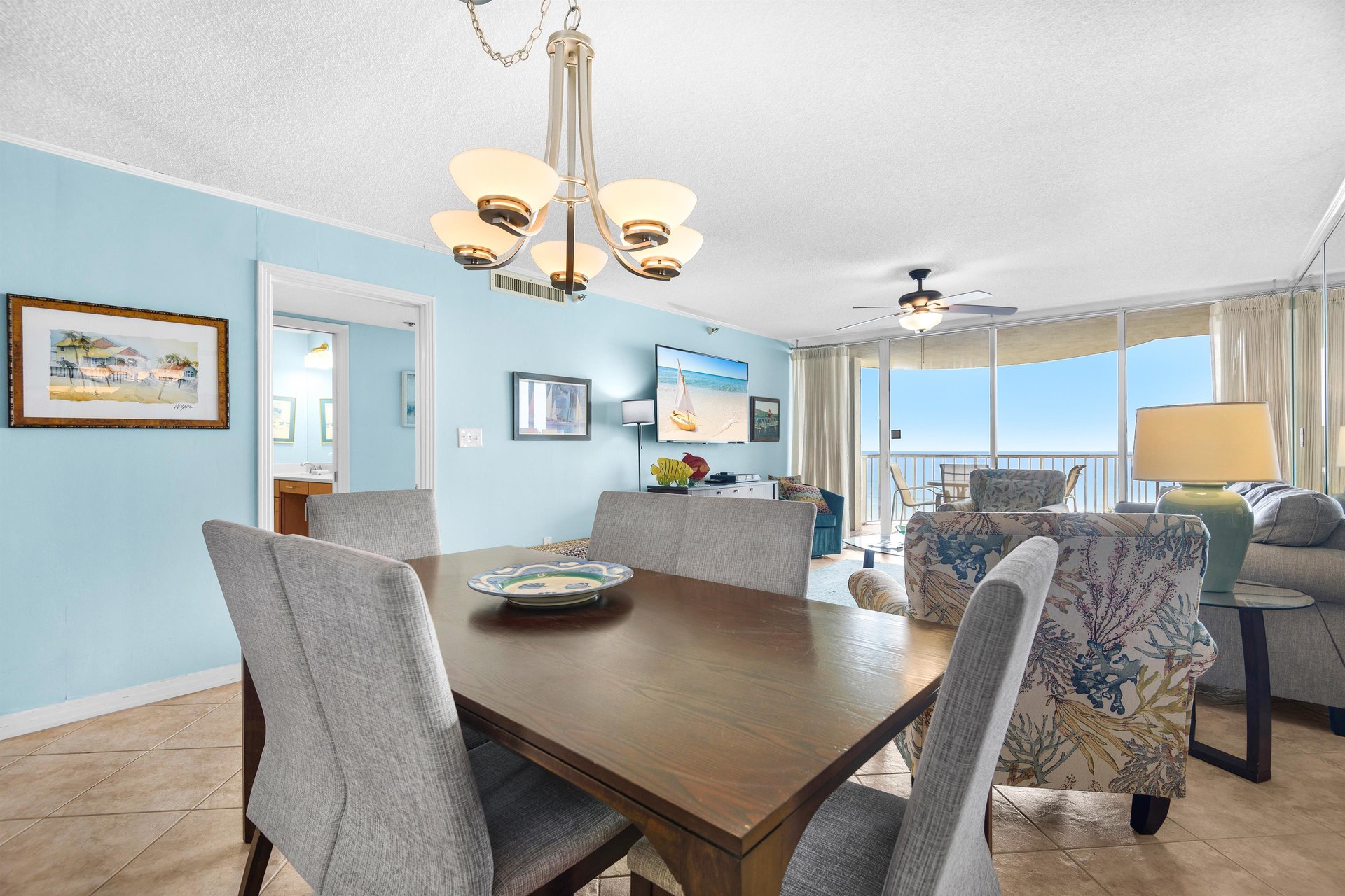 Gather around this elegant dining table where ocean views through floortoceiling windows create the perfect backdrop for your memorable meals together.