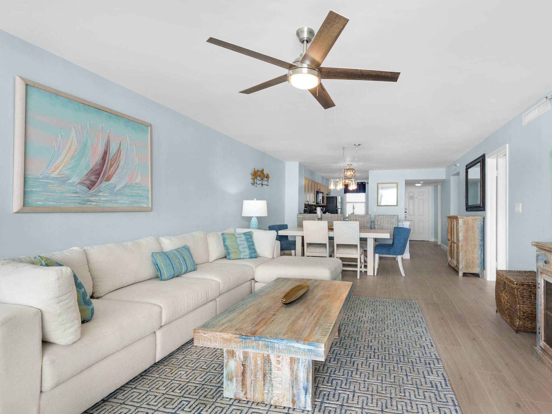 Relax in your coastalthemed living space with plush seating, nautical artwork, and an open layout flowing seamlessly into the dining area.
