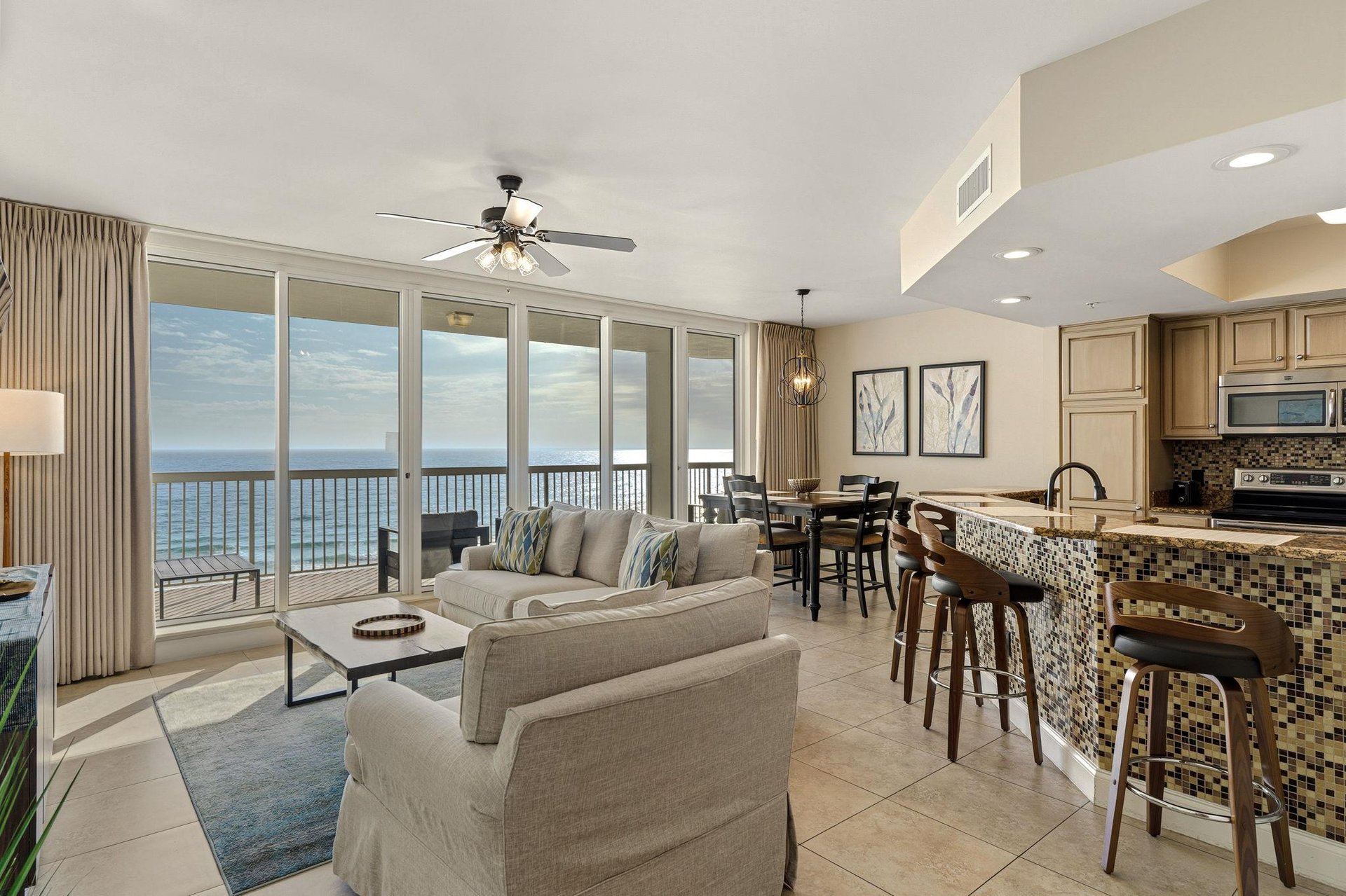 Unwind with stunning ocean views from your openconcept living space with modern kitchen and comfortable seating.