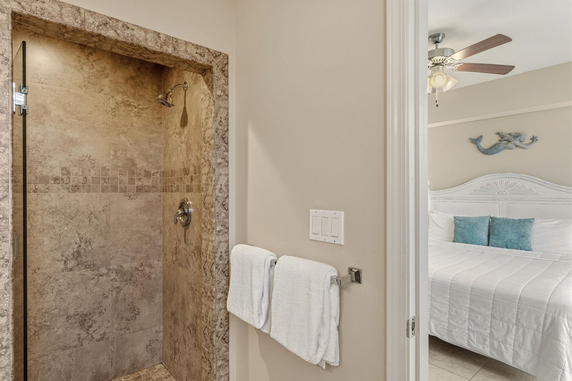 Bathroom 2 with a private spalike shower with natural stone tiles and modern fixtures, perfectly positioned near your peaceful bedroom retreat.